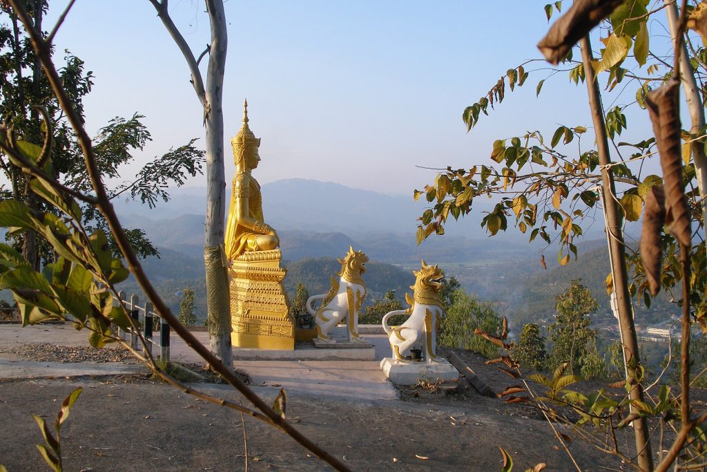 帕塔多伊功穆寺山脊上的金色立佛、白色护栏与远处山谷