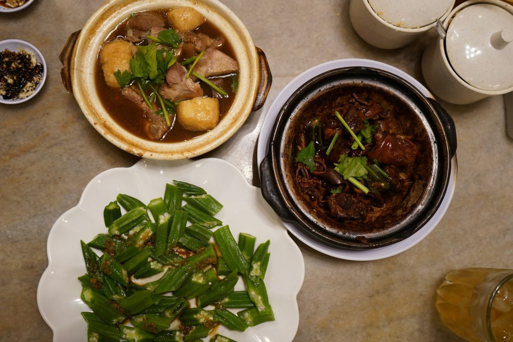 俯拍两煲肉骨茶与一盘秋葵菜肴
