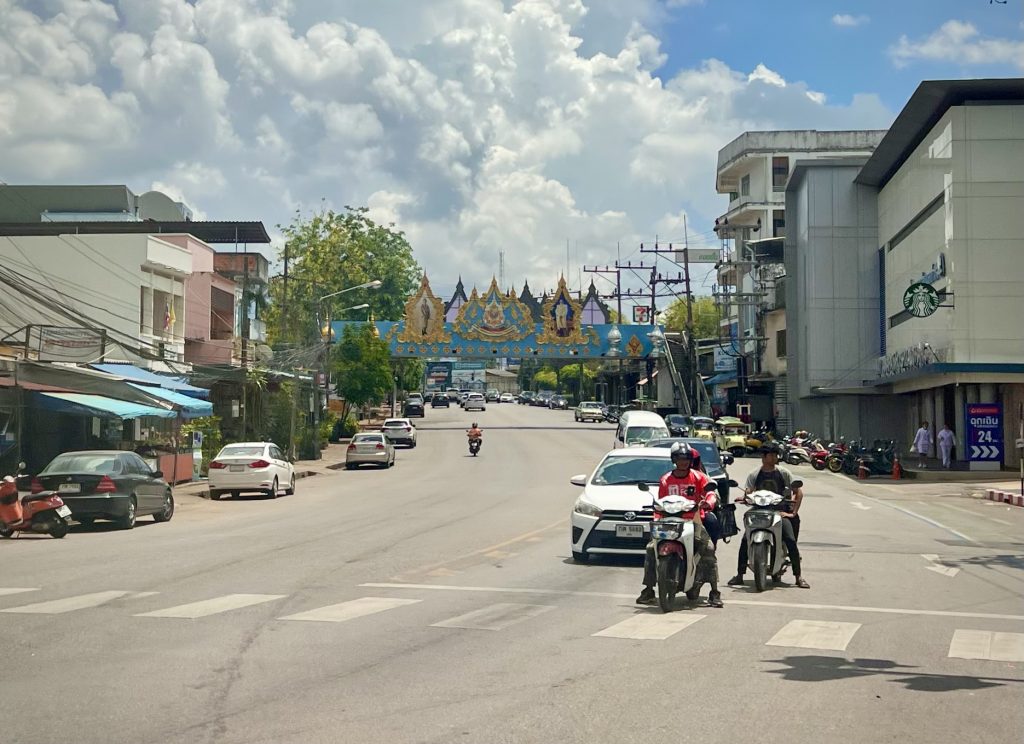 董里市区一条有汽车摩托车与商业建筑的宽阔街道